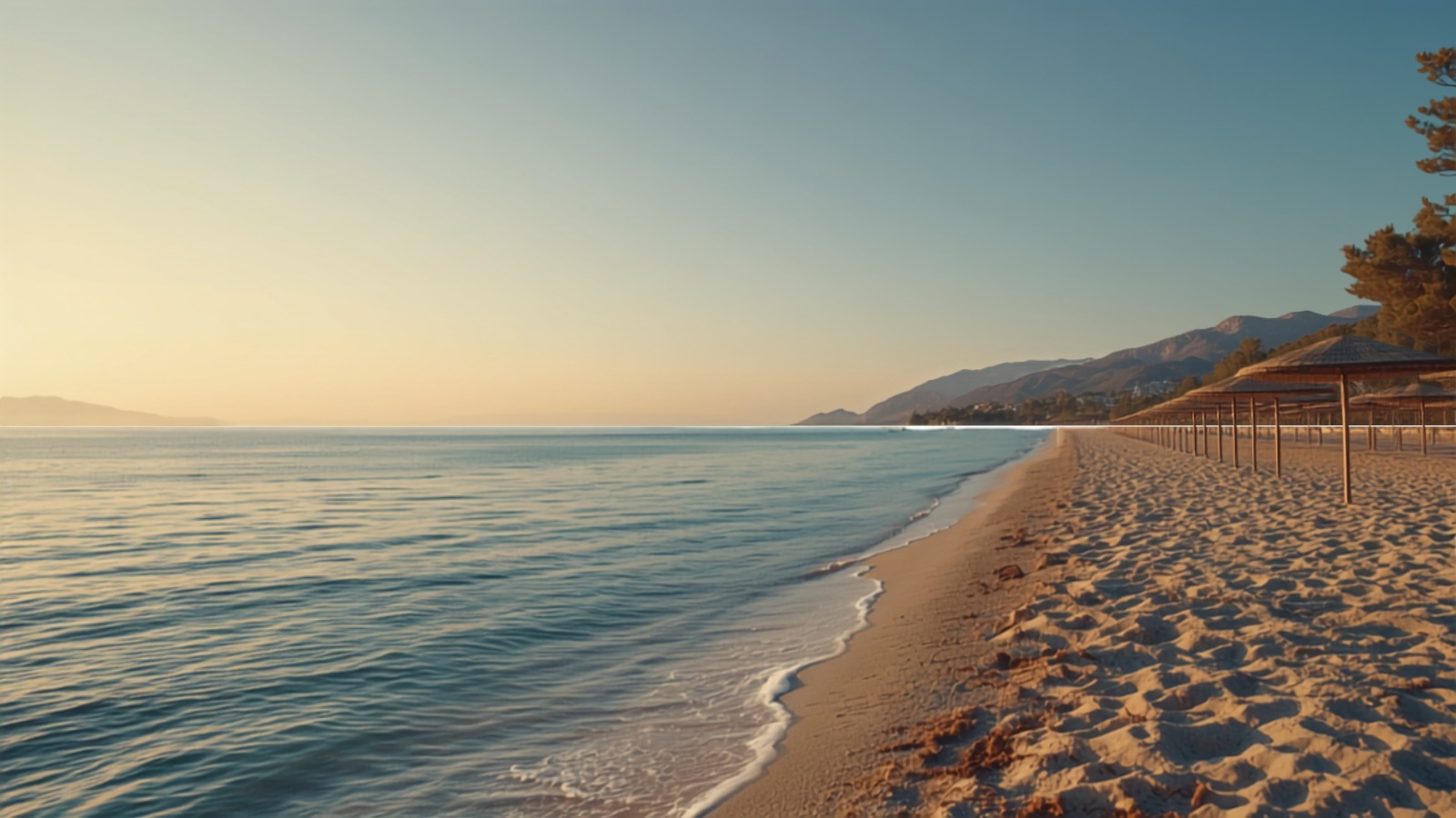 Greek beach with turquoise sea and parasols at sunset - preview of the 2027 holiday season.